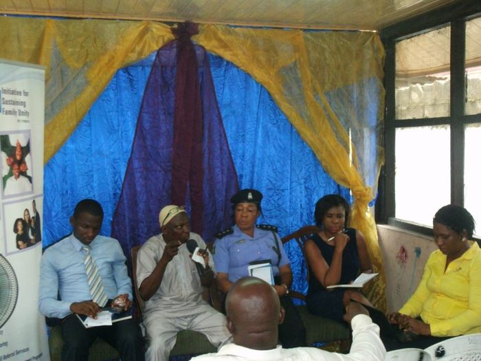 A Family Roundtable in session, panellists taking questions beneath the Initiative for Sustaining Family Unity banner
