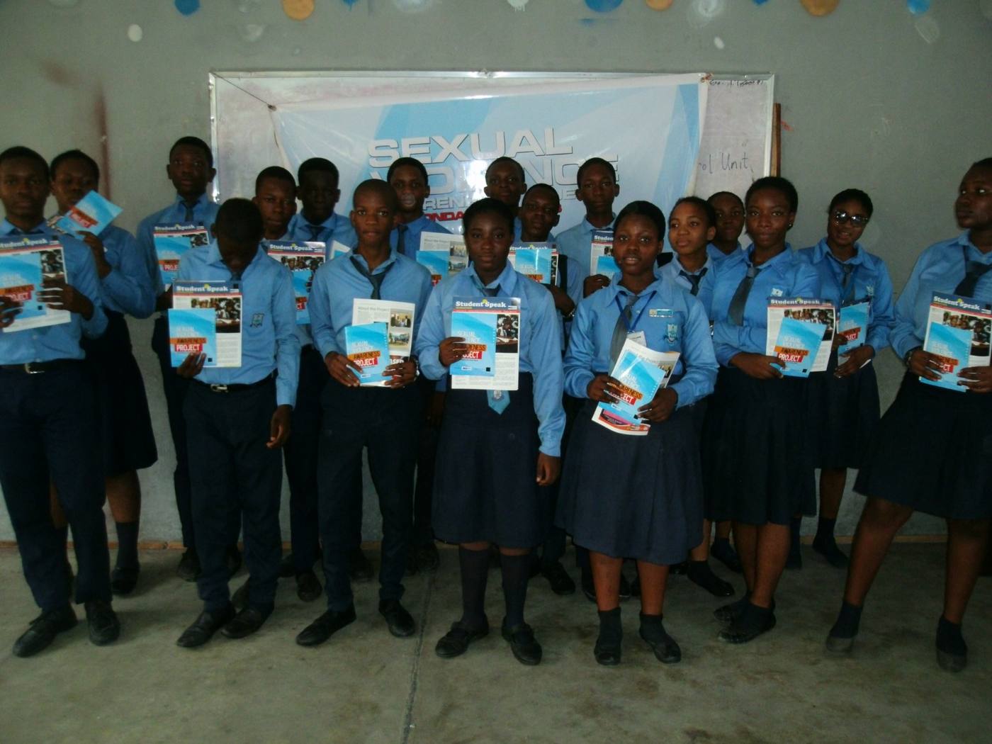 Students holding the project handbook at the end of a session
